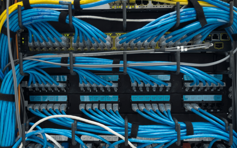 Copper patch cords terminated across patch panels in a network cabinet
