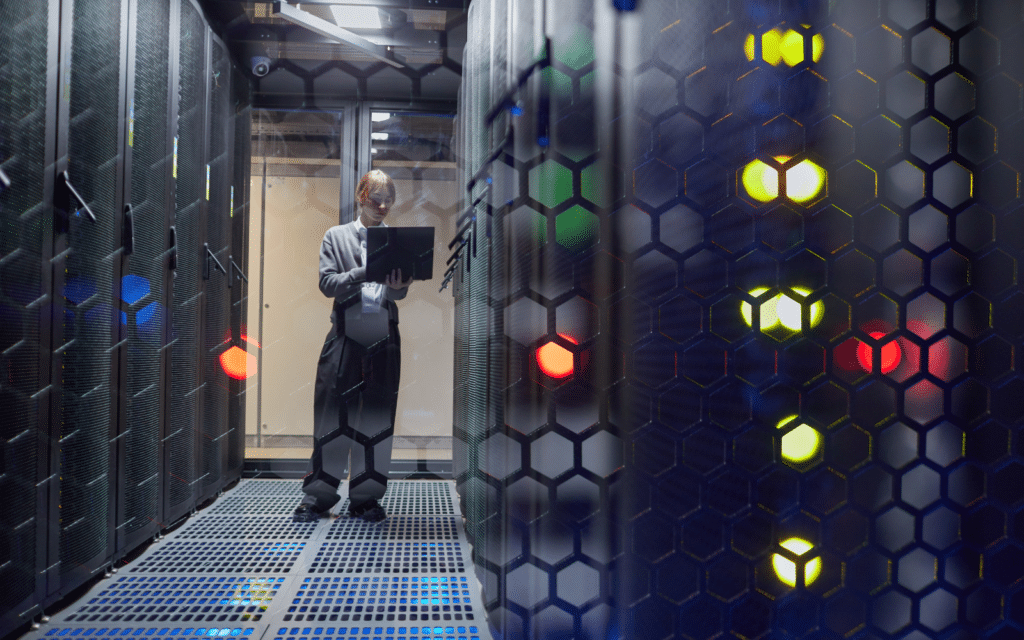 Data center aisle with cabinet doors closed and equipment status lights showing