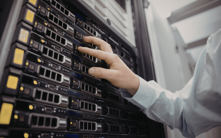 Technician seating a rack-mounted server into a cabinet