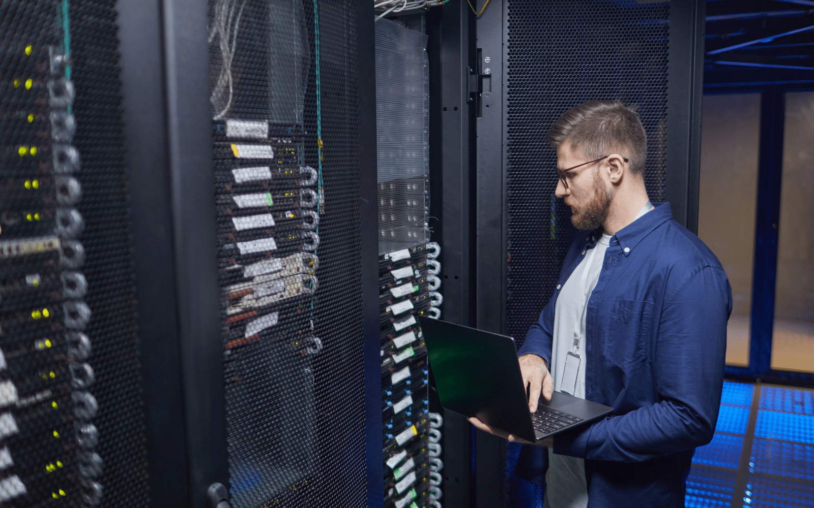 Remote hands technician checking network equipment and cabling in a technical room