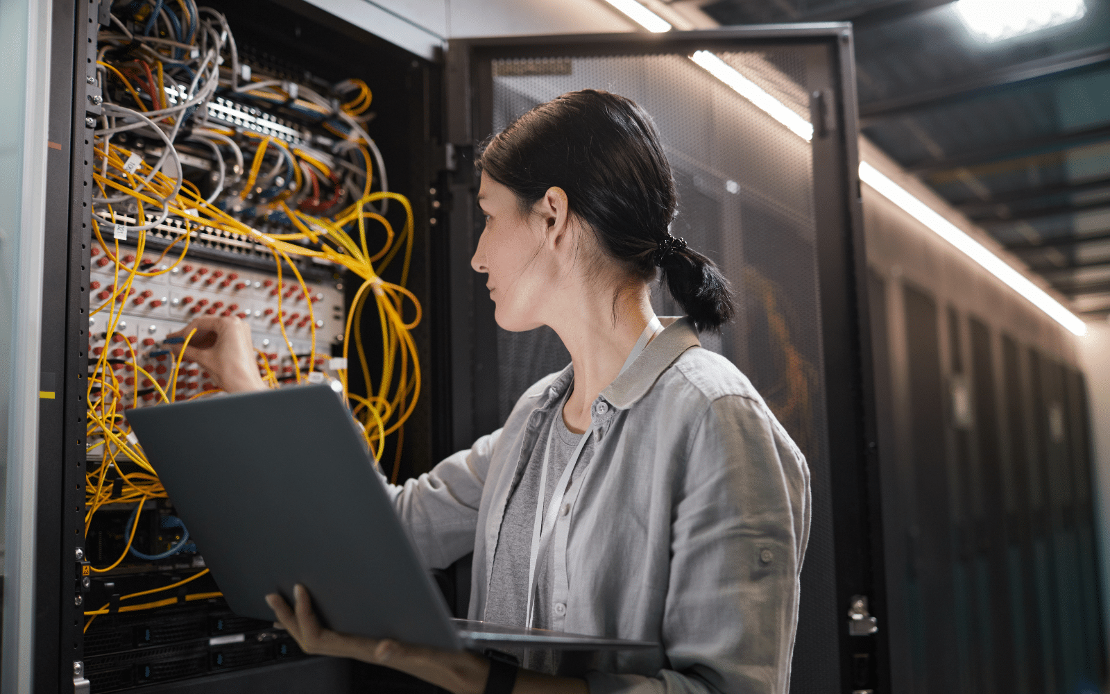 Onsite IT support technician checking network equipment at a business location