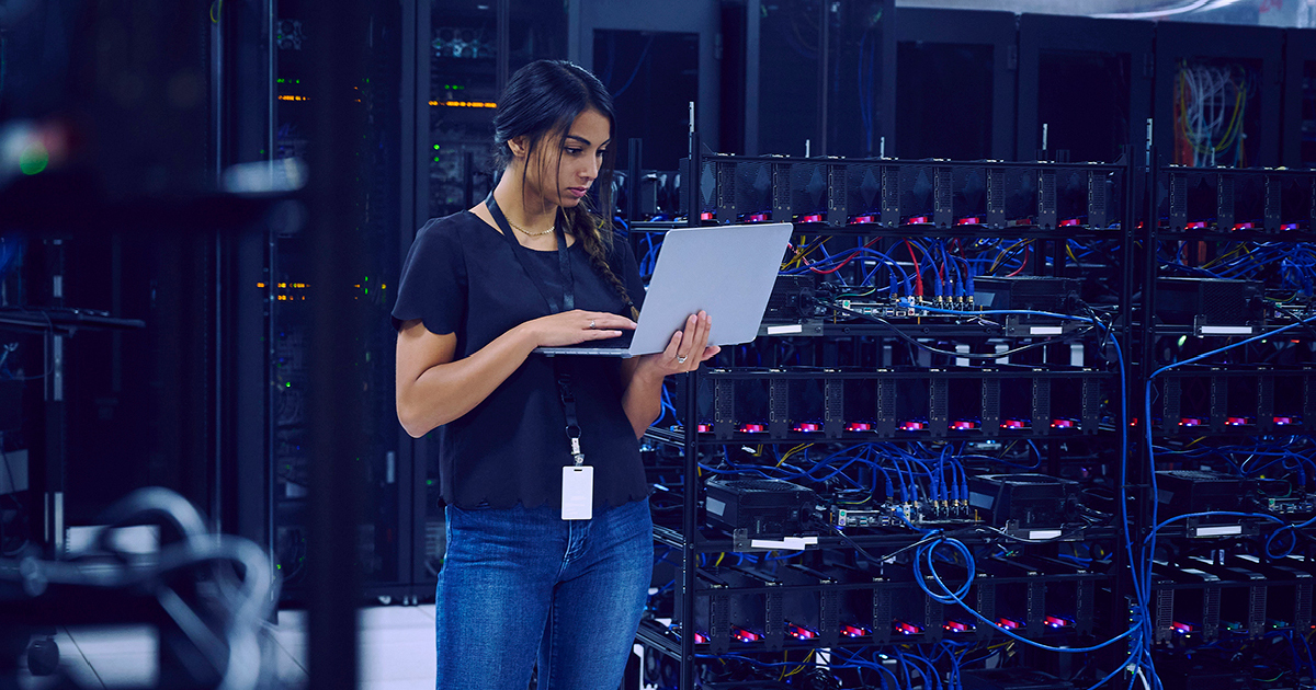 IT professional reviewing systems in a server room