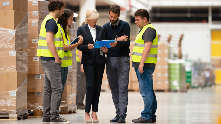 Warehouse team staging and kitting equipment for a multi-site technology deployment