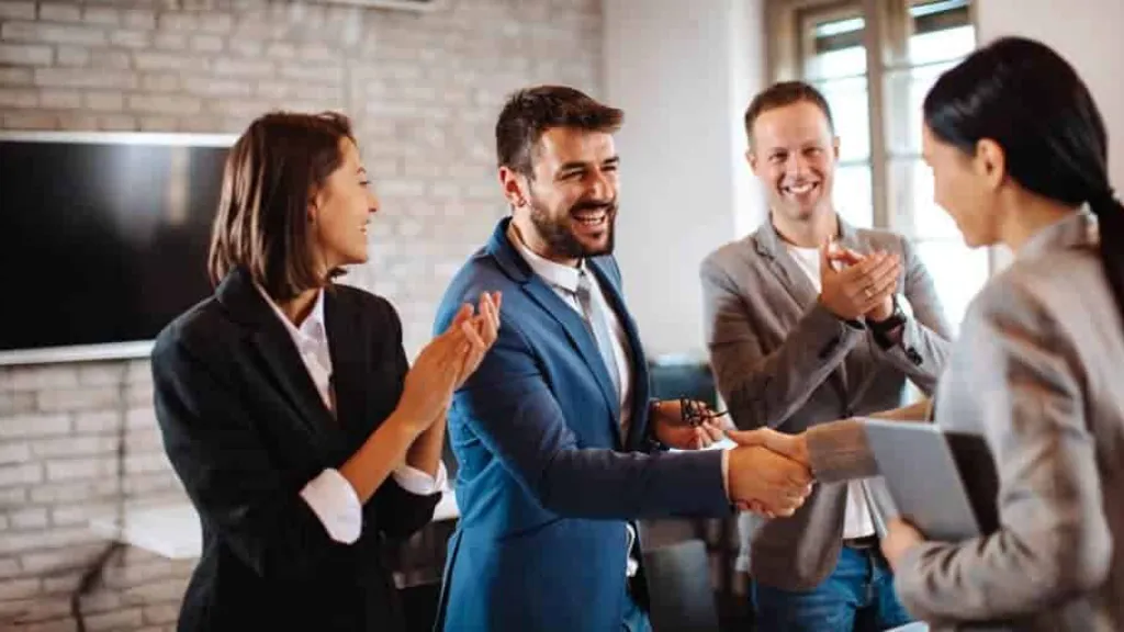 Business team shaking hands in an office meeting