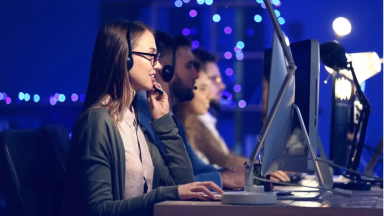 Public-sector support team working at monitors in an office operations room