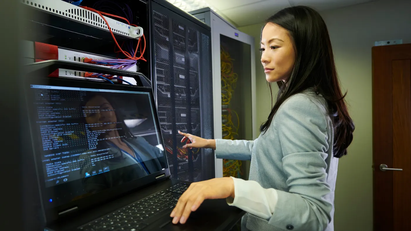 Onsite technician checking network and edge equipment in a server room